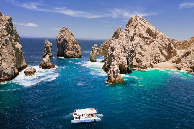 A family enjoying a breathtaking sunset cruise in Cabo San Lucas, with the sky ablaze with vibrant colors and smiles on their faces